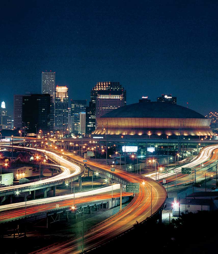 The Mercedes Benz superdome illuminates downtown New Orleans