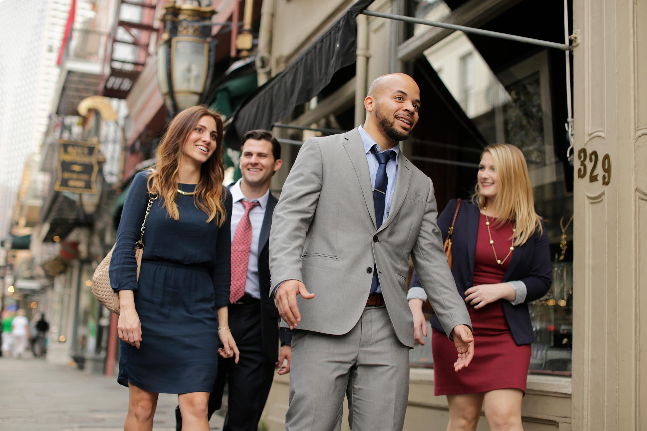 A group of business people walk downtown