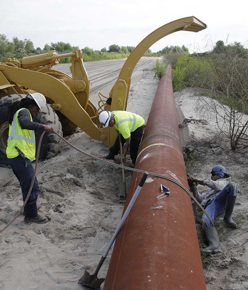 A team of Weeks Marine workers place pipelines