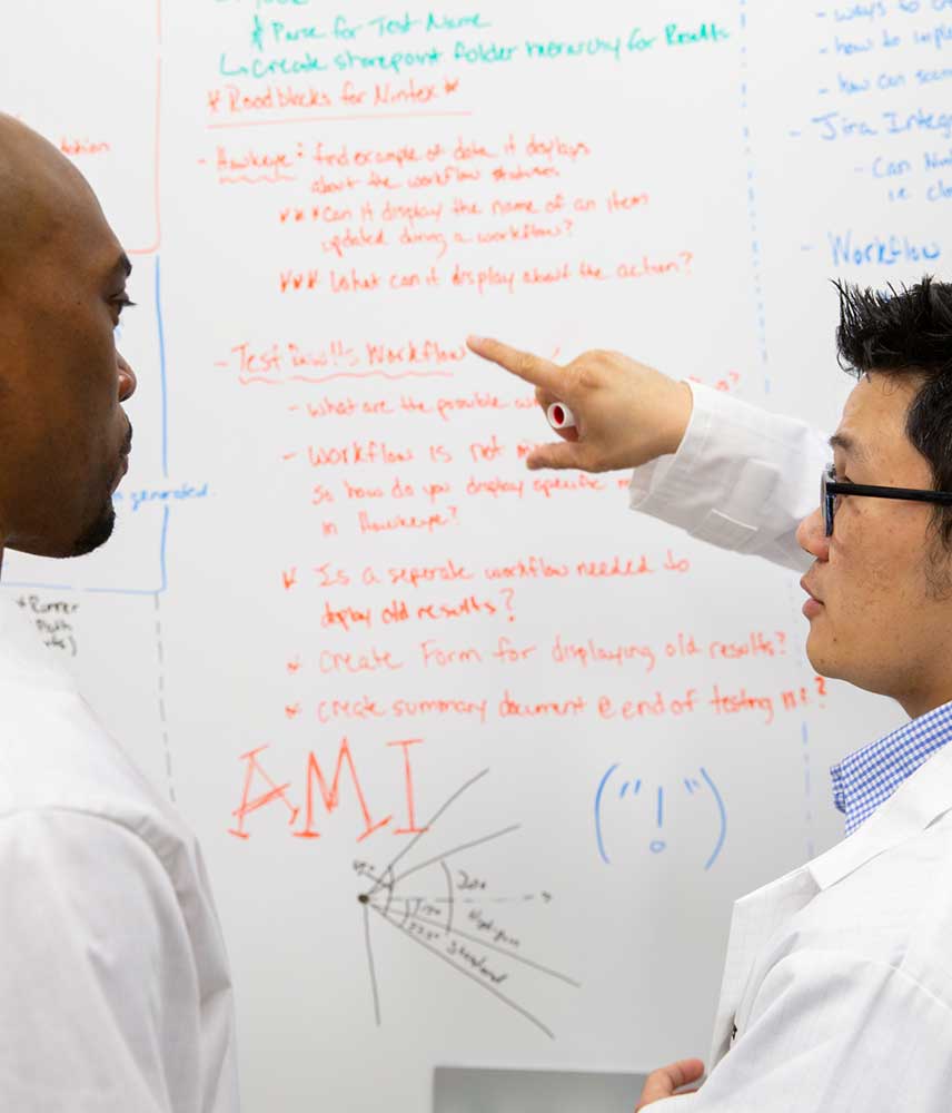 Scientists at Entergy work to solve problems on a white board