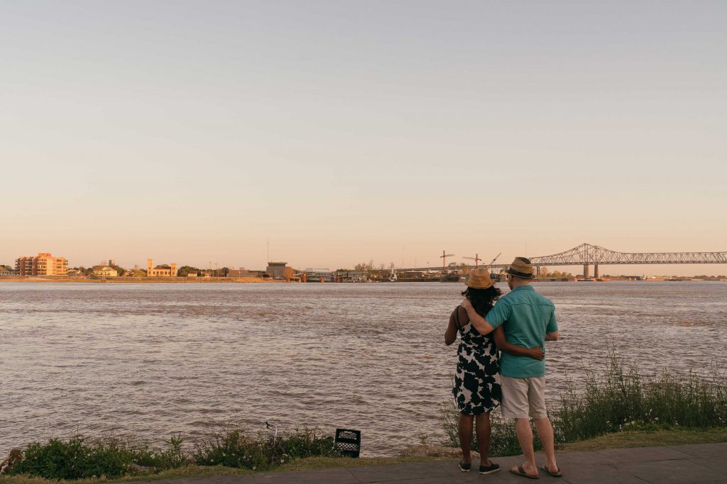 A couple standing along the baks of a river in New Orleans